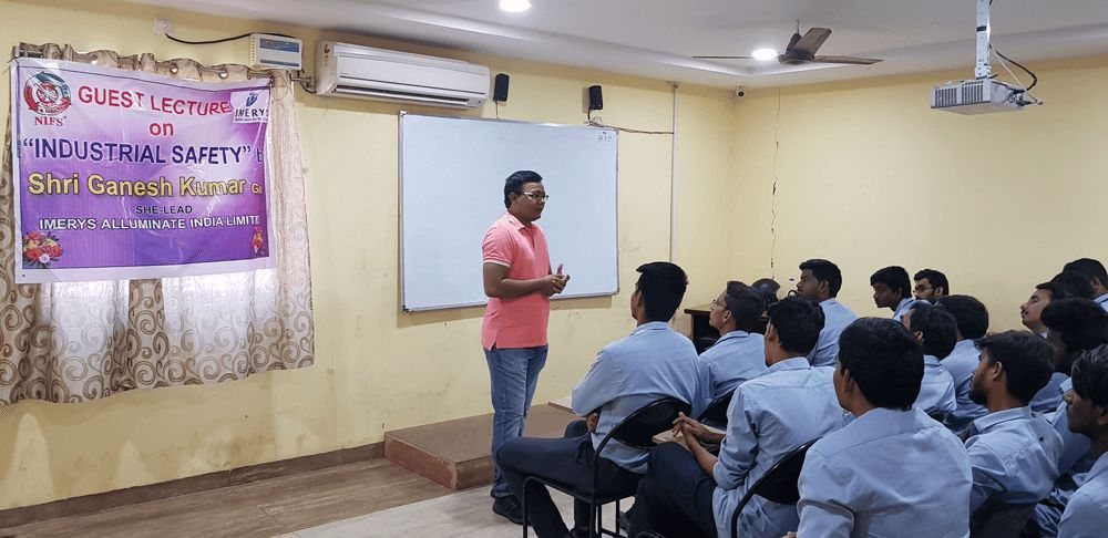 Industrial safety guest lecture in progress at a NIFS Visakhapatnam classroom with students listening