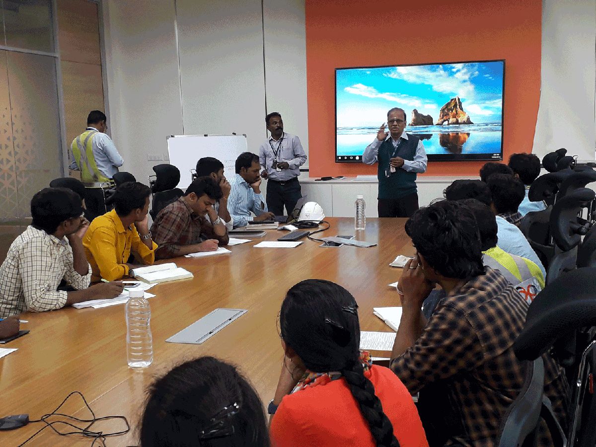 A guest safety professional addressing NIFS students in a corporate meeting room